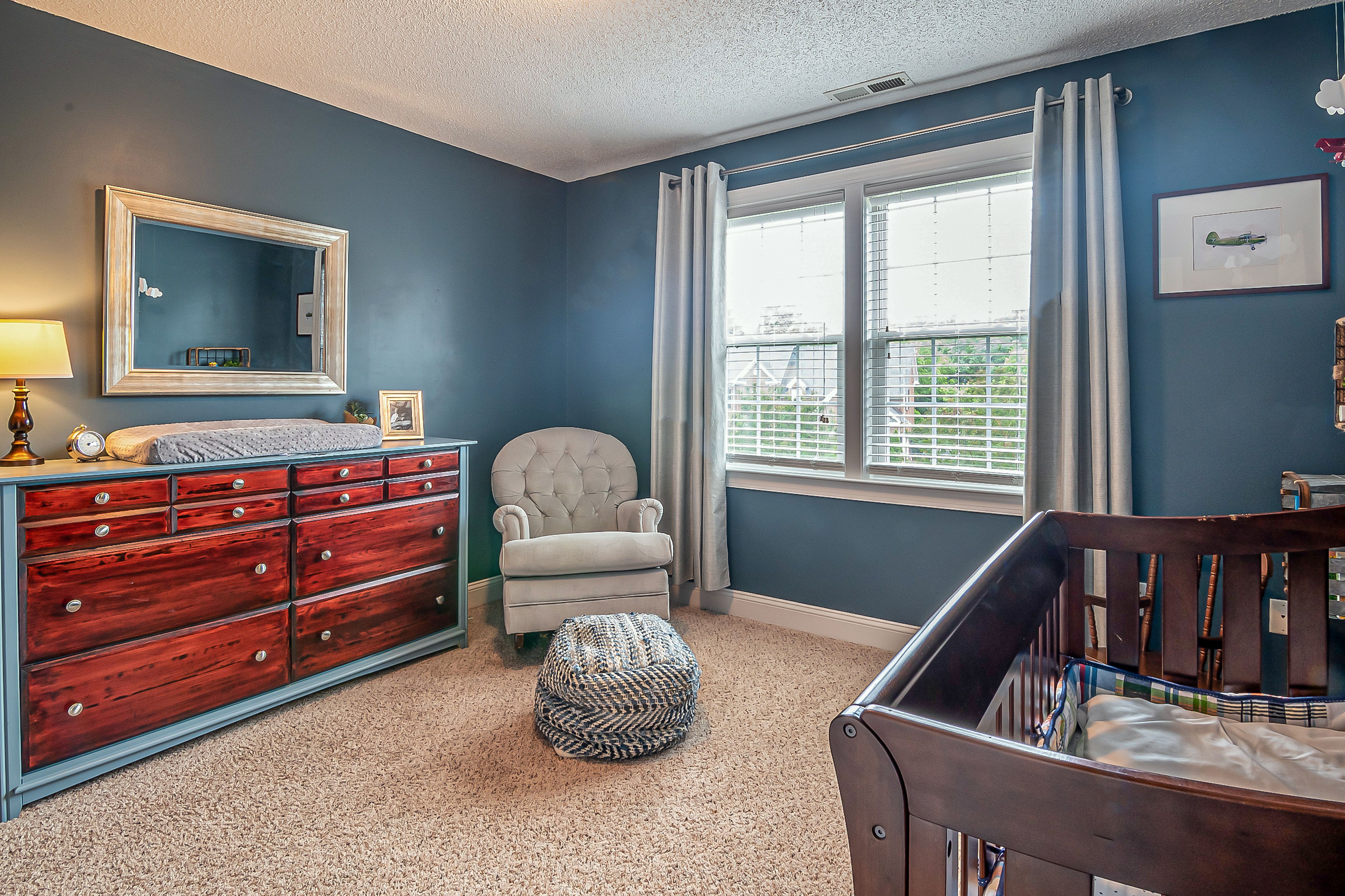 Bright nursery interior that provides inspiration for displaying a homemade baby growth chart.